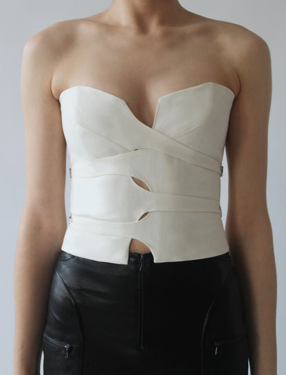 Front view of the SP_CE.01 Interlace Corset in woven wool, with interlacing straps that buckle at sides.